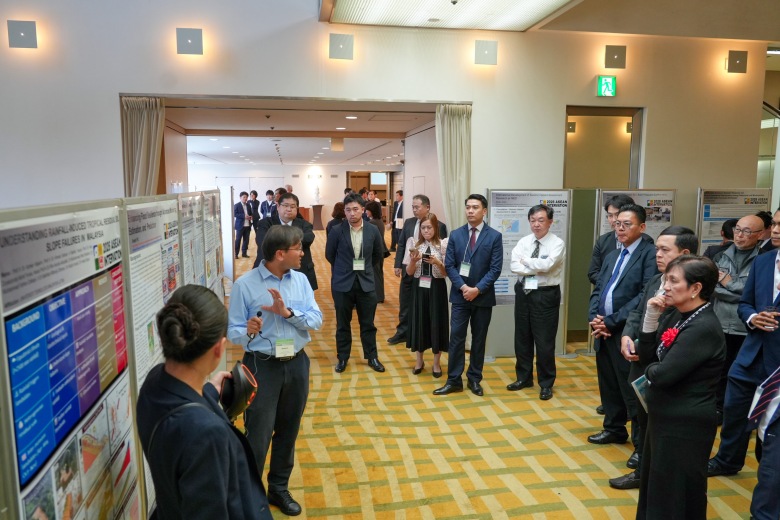 Participants engaging in discussions during the World Café poster session. 